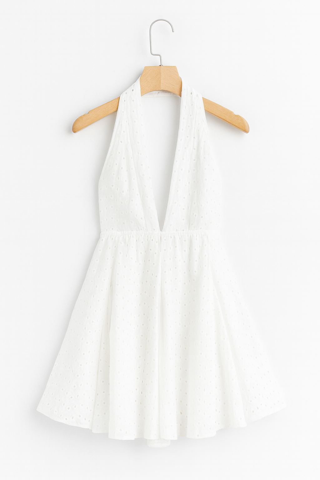 White dress on a hanger against white background