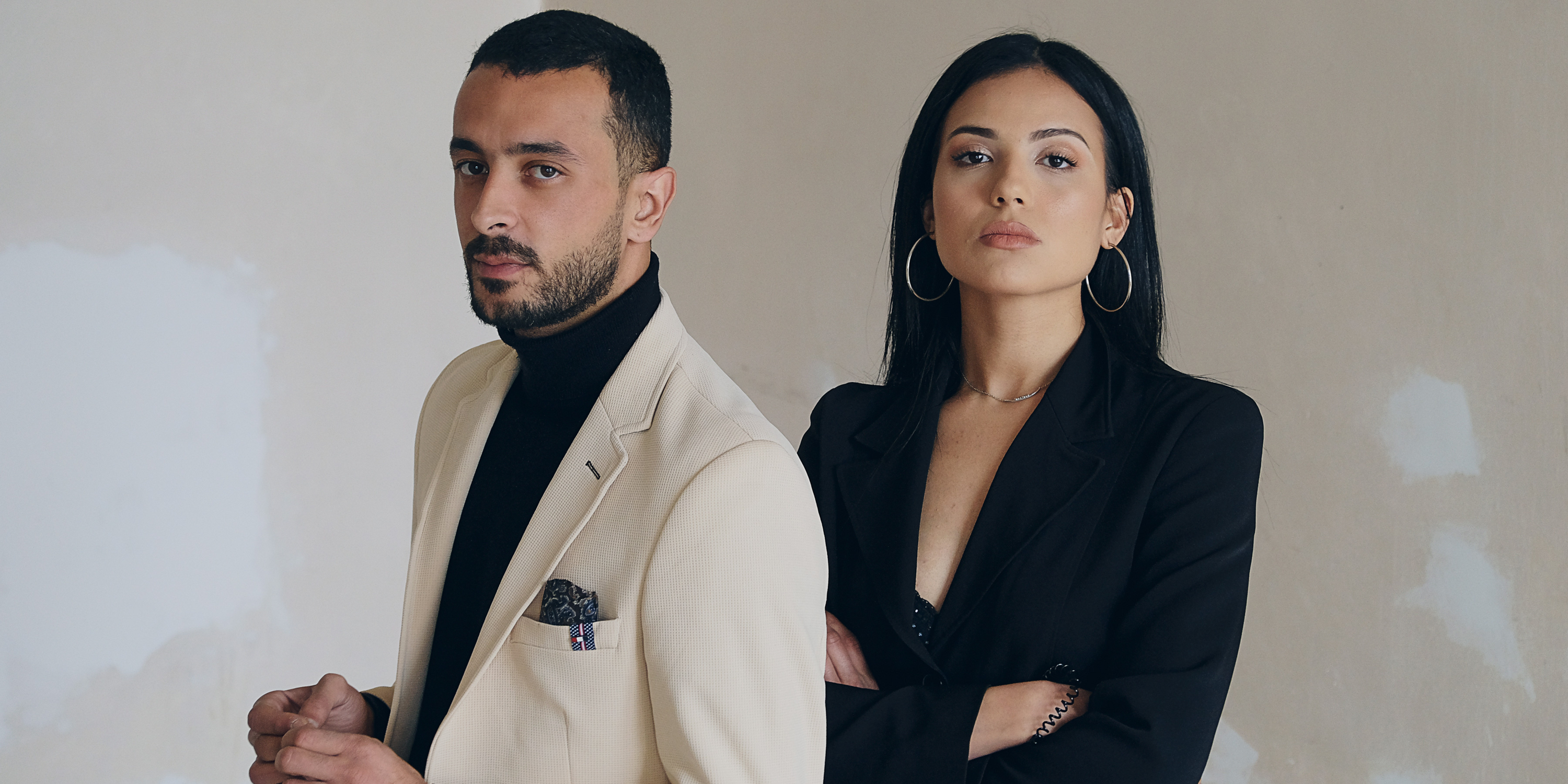 Man and woman standing against wall