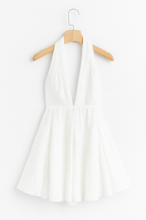 White dress on a hanger against white background
